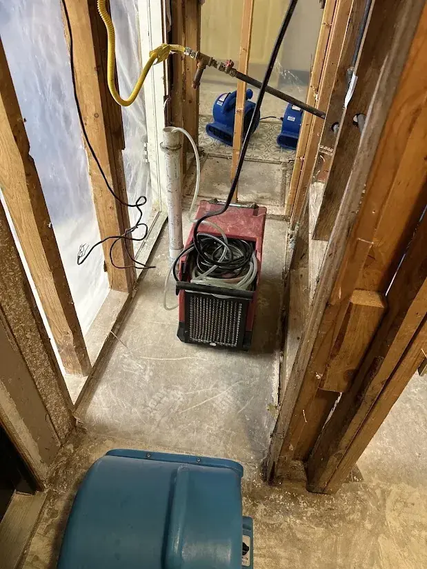 A dehumidifier pulling moisture from a hallway in a Miami, FL home