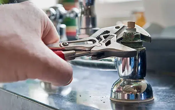 Wrench on a burst supply line in a Miami home